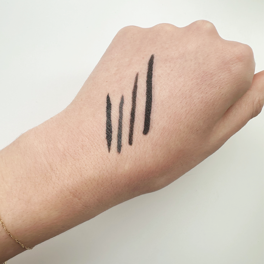 eyeliner testing swatches on editor's hand