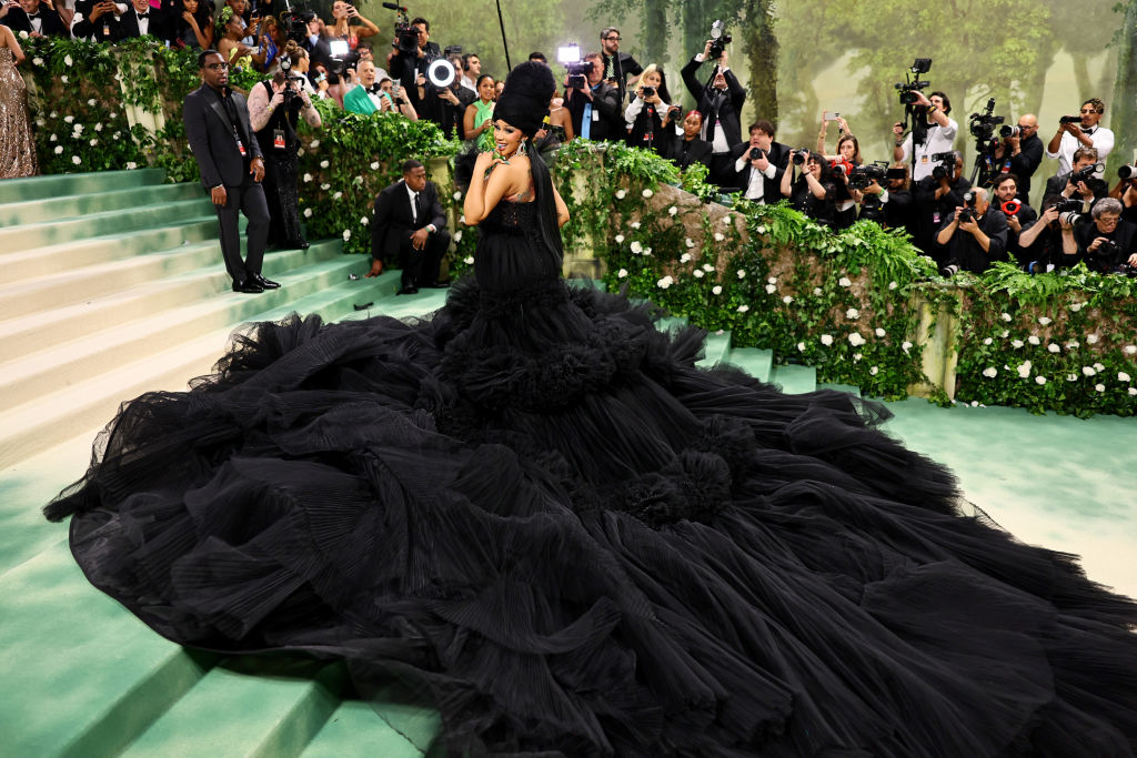 Cardi B in a black gown with long tail at The 2024 Met Gala Celebrating