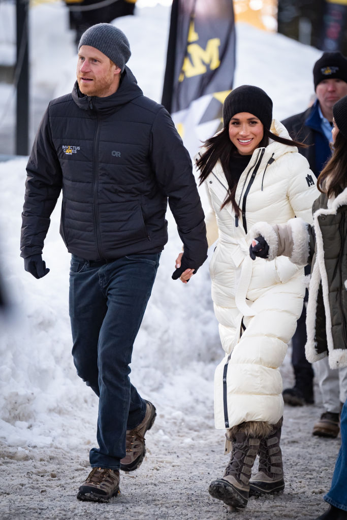 Prince Harry, Duke of Sussex and Meghan, Duchess of Sussex during day two of the 2025 Invictus Games on Feb. 10 in Whistler, Canada, Mackage coat, Sorel boots, black and white, royals, street style
