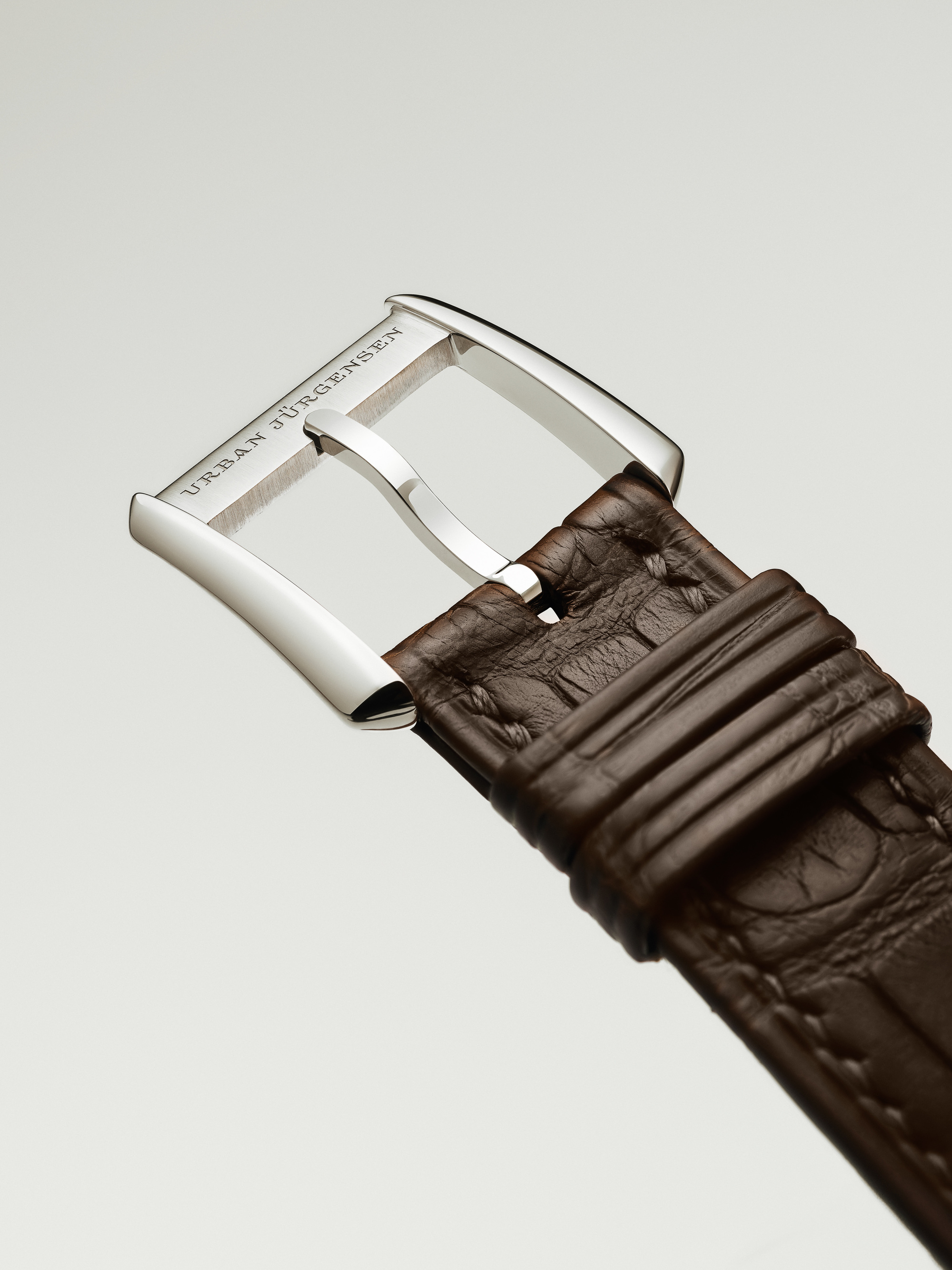 A buckle bearing the Urban Jürgensen name.