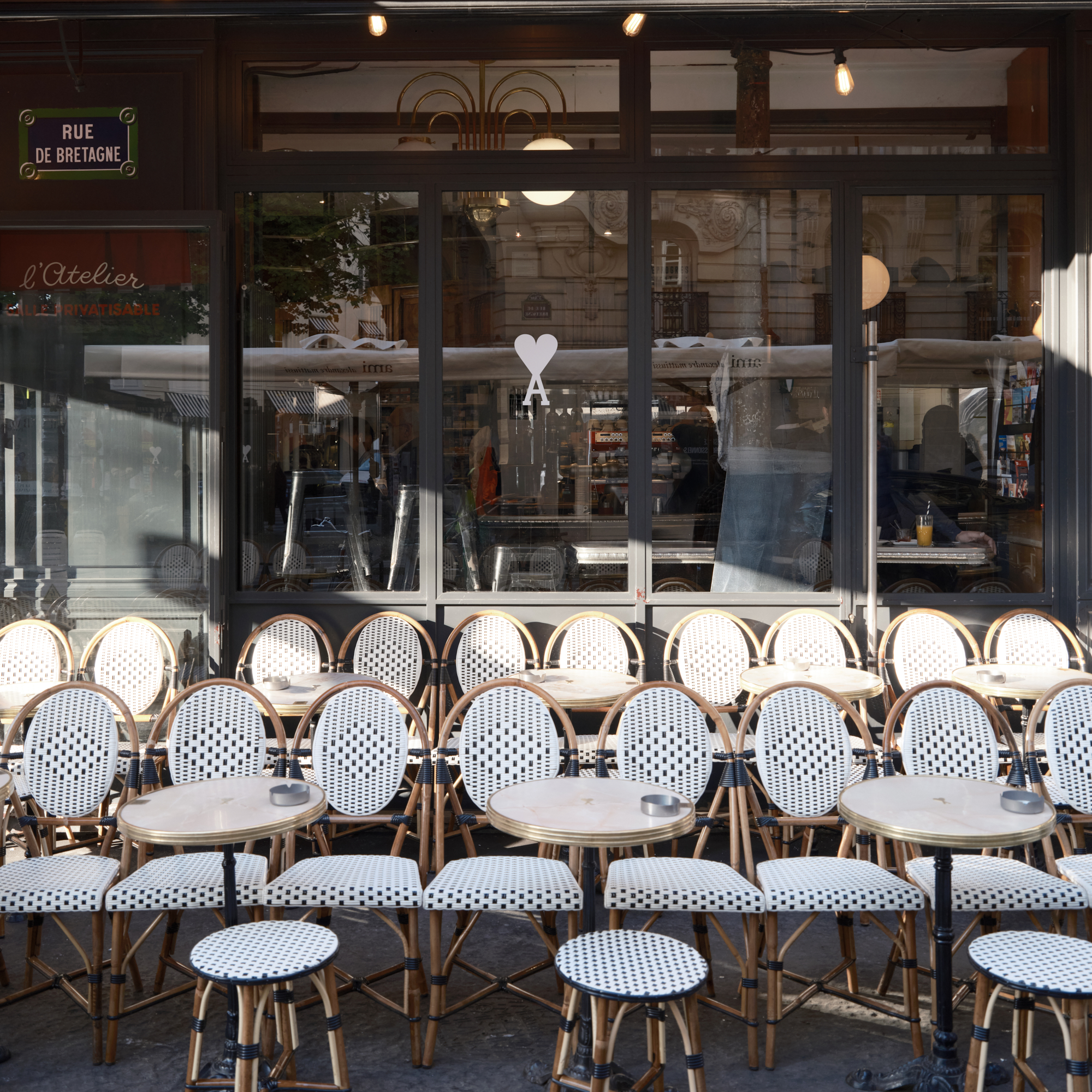Ami Paris takover of café Le Progrès, which also includes branding on tables