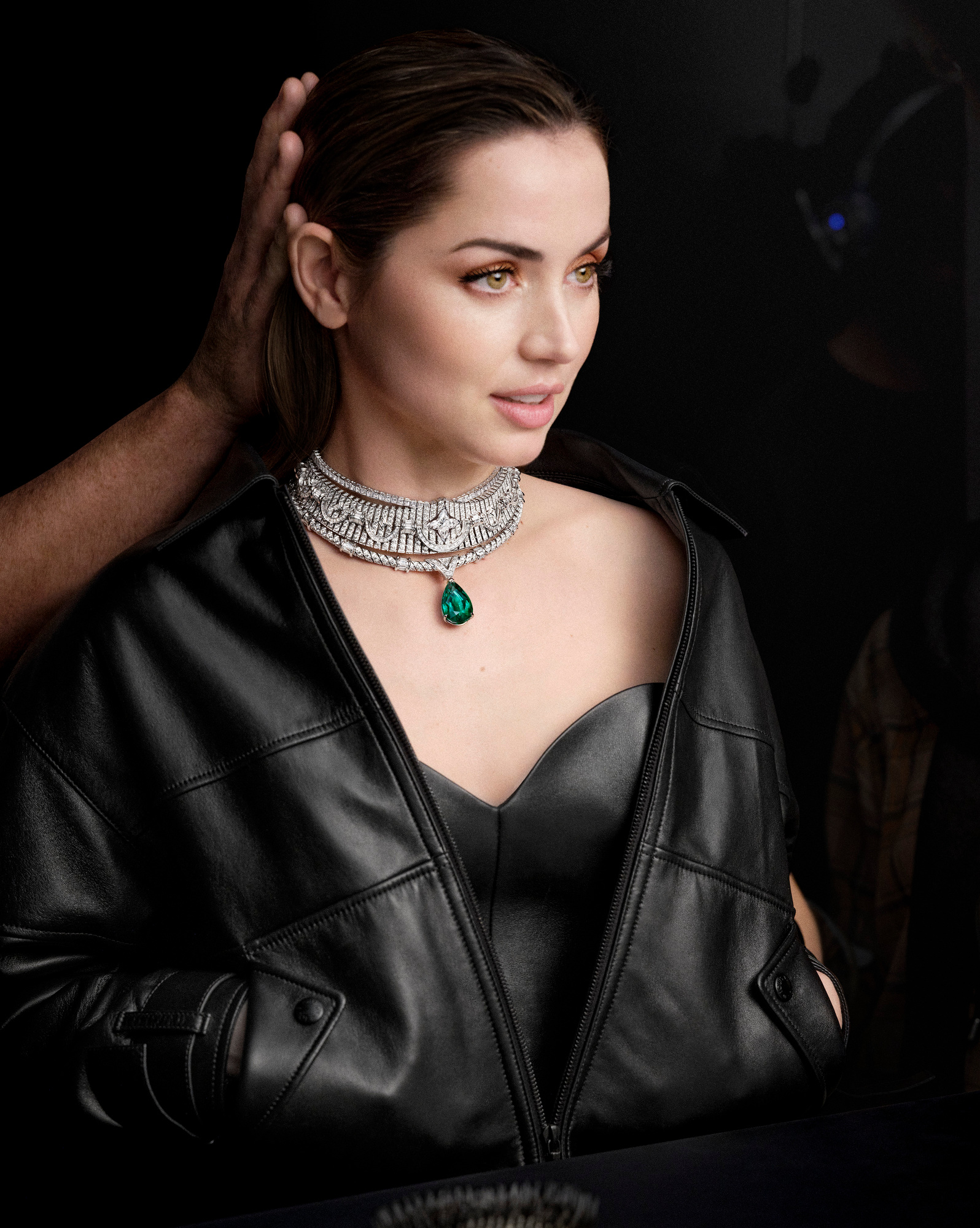 In a behind-the-scenes shot of the upcoming high jewelry campaign, Ana de Armas wears the Apogée necklace from the Virtuosity collection, featuring a 30.75-carat emerald and a10.56-carat LV Monogram Star cut.