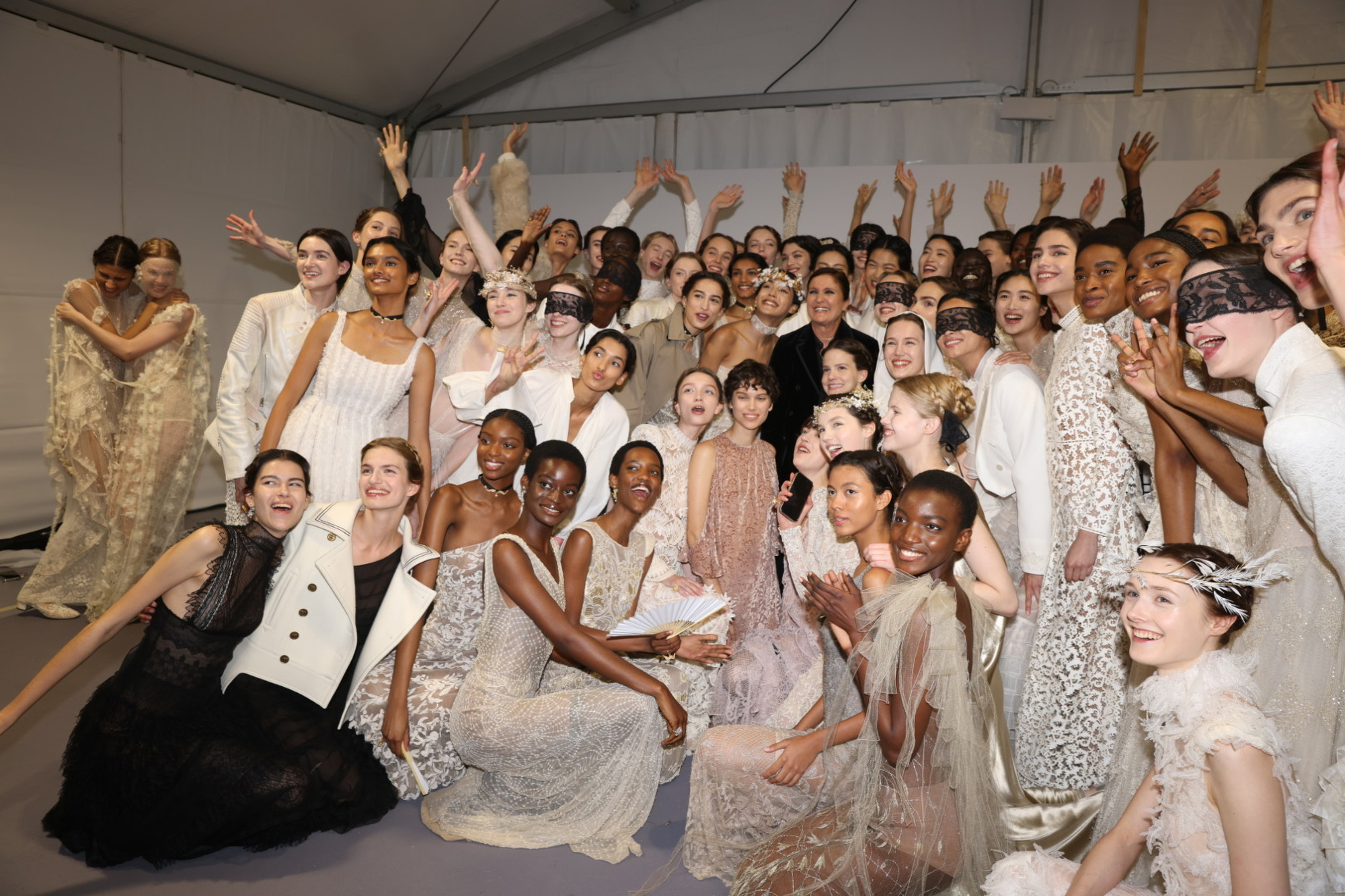 Maria Grazia Chiuri backstage with models after the Dior Cruise 2026 show in Rome