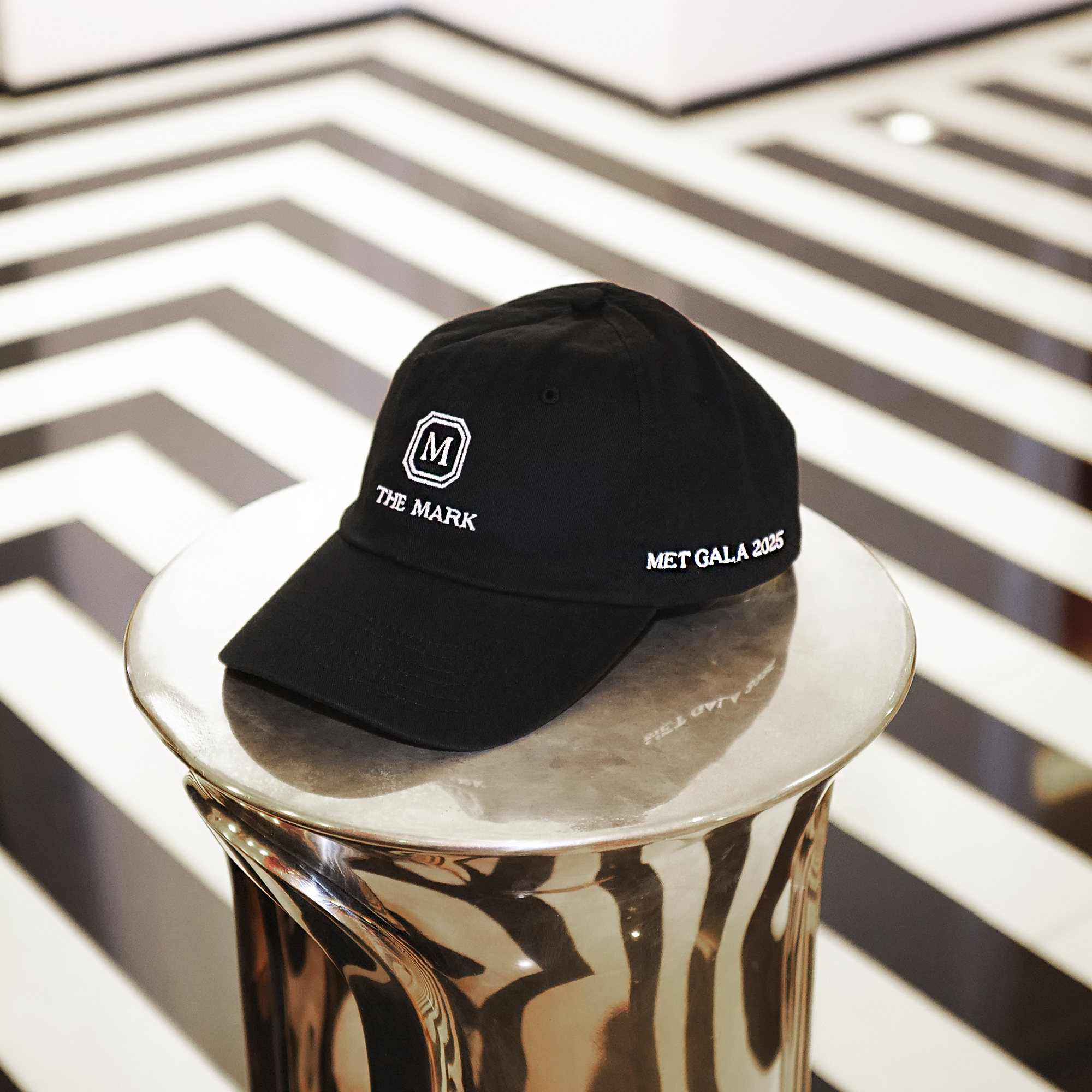 The Mark's Met edition baseball cap in the New York hotel's lobby on a silver side table.