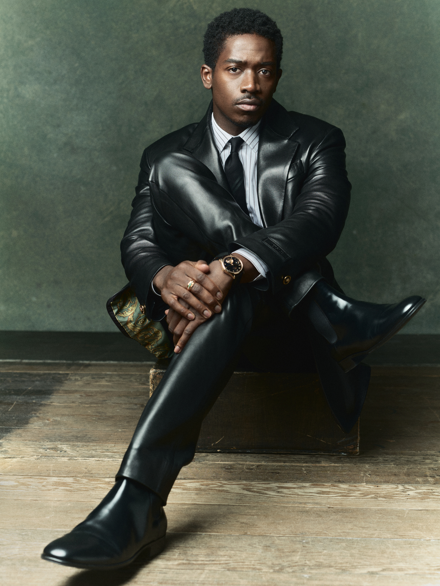 Versace leather jacket and pants; Cesare Attolini superfine cotton shirt; Thom Browne tie; Gianvito Rossi boots; IWC Portugieser Hand-wound Tourbillon Day and Night watch in black with 18-karat Armor Gold® case.