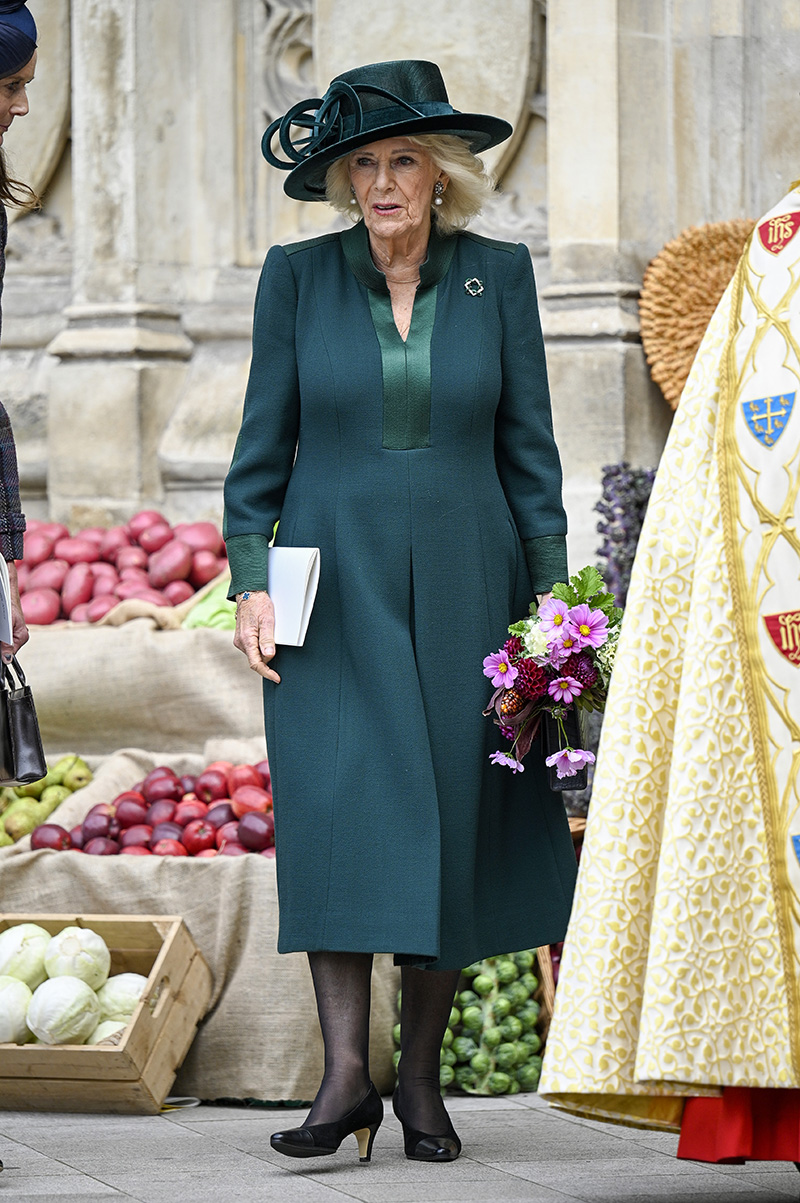 Queen Camilla wears an emerald green dress by Anna Valentine with coordinated brooch and hat at The National Harvest Festival Service at Westminster Abbey on Oct. 16, 2025 in London.