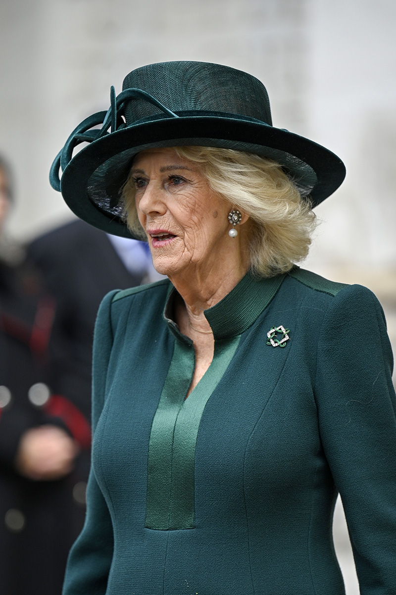 Queen Camilla wears an emerald green dress by Anna Valentine with coordinated brooch and hat at The National Harvest Festival Service at Westminster Abbey on Oct. 16, 2025 in London.