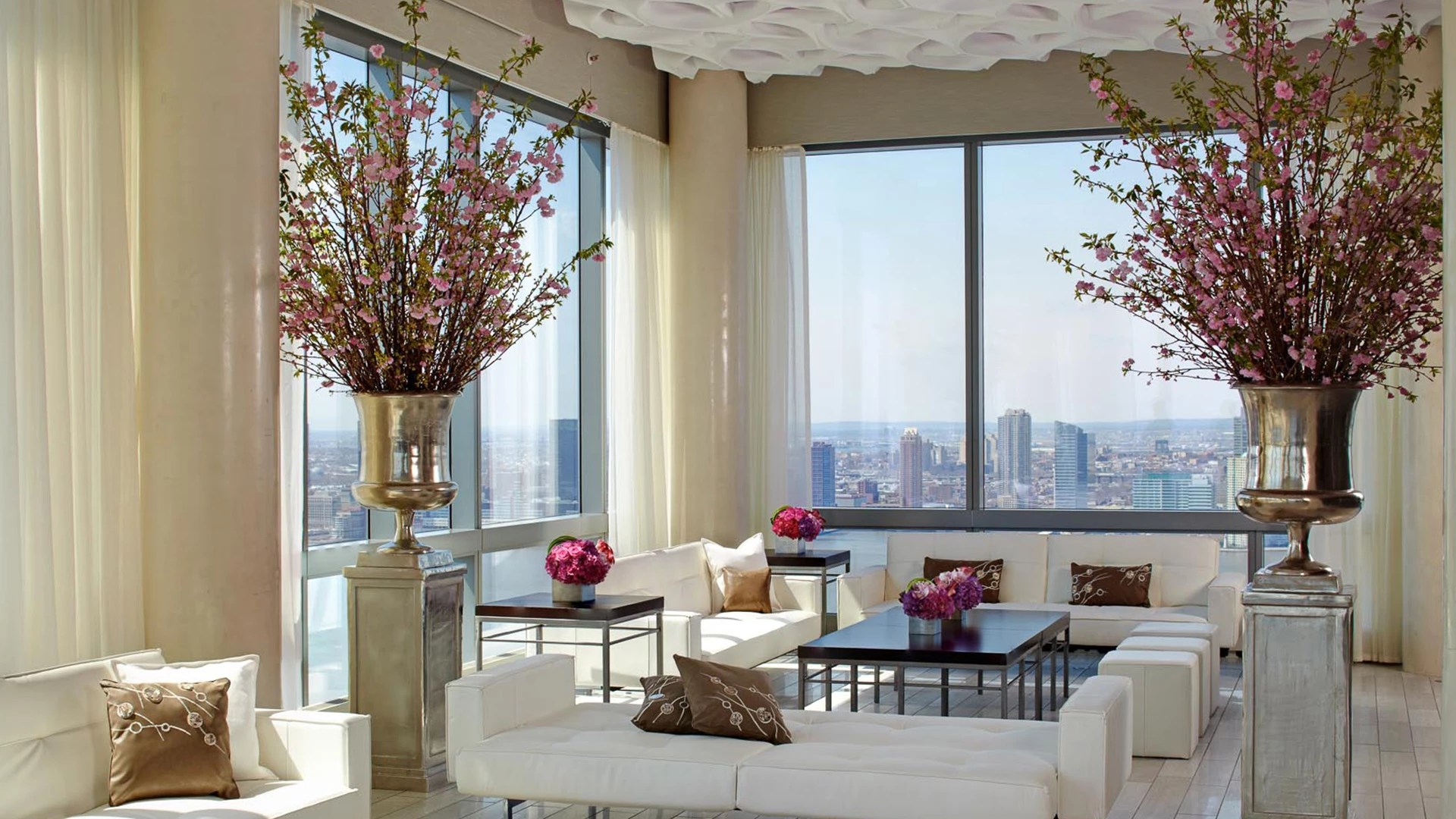 inside view of suite at The Dominick hotel in soho, decorated with flowers, white sofas, and more