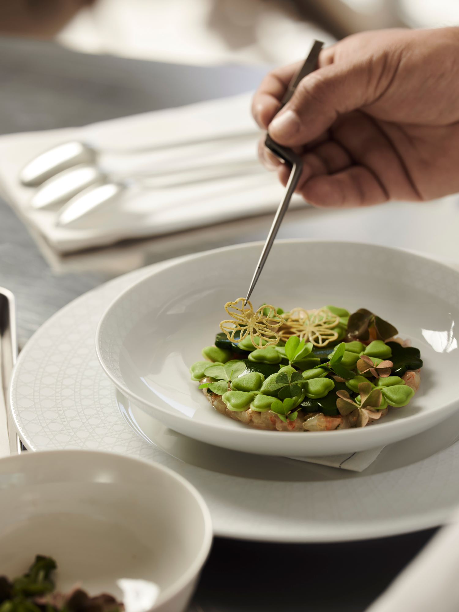 Chef Mauro Colagreco prepares his Champ de Trèfles starter at the Monsieur Dior restaurant in Saint-Tropez