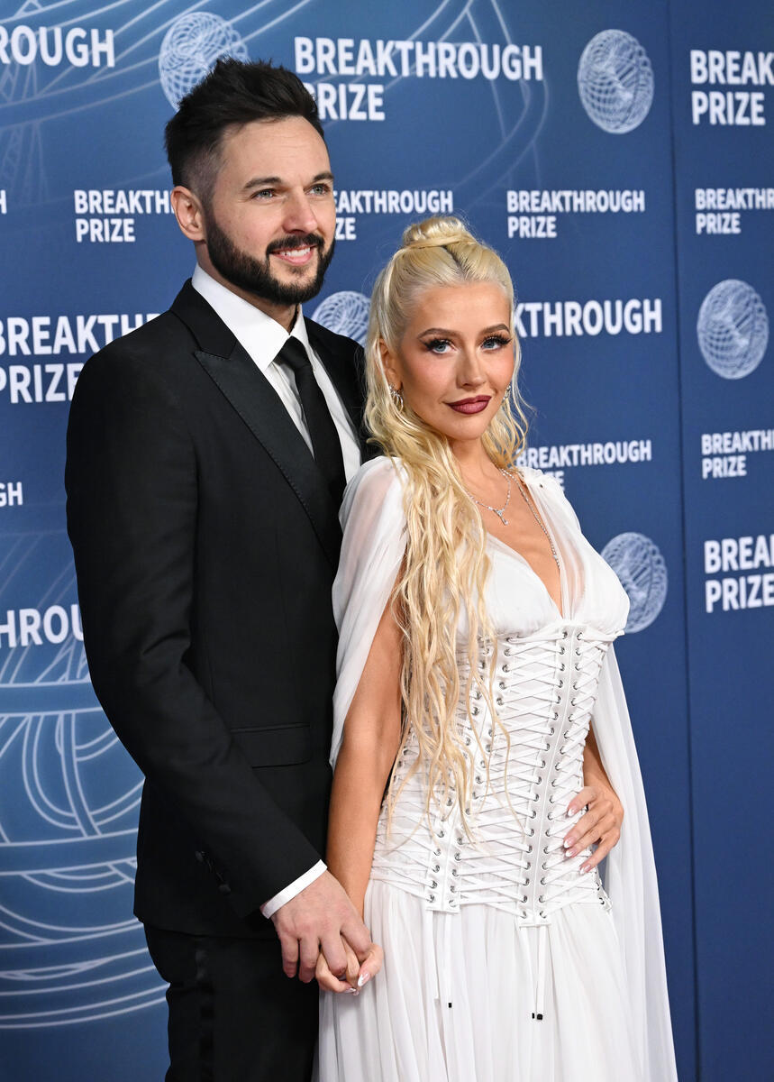 Matthew Rutler, Christina Aguilera at The 11th Breakthrough Prize Ceremony held at Barker Hanger on April 05, 2025 in Santa Monica, California, Dolce & Gabbana white semi-sheer spring 2024 dress with corset details